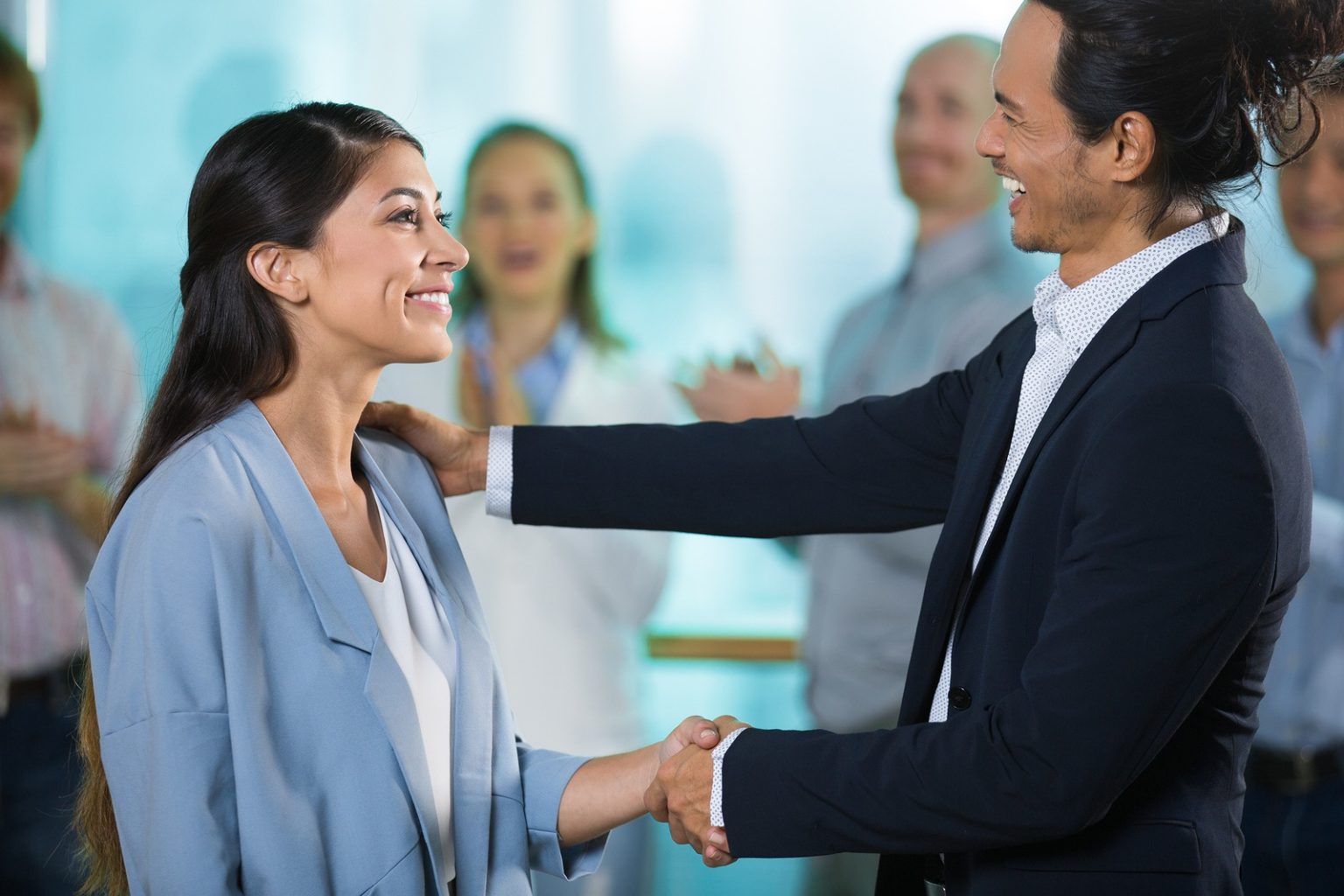a business man greeting a woman